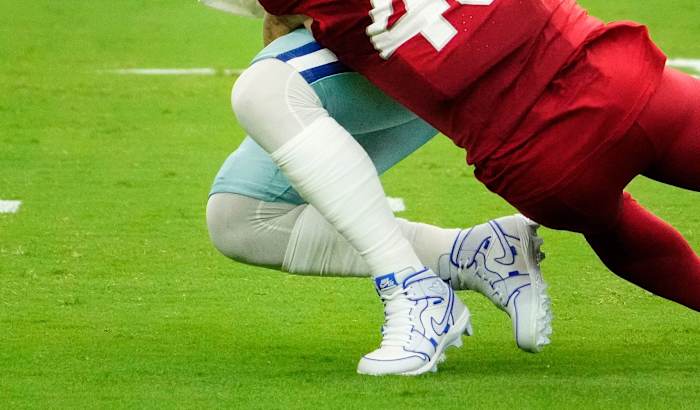 Arizona Cardinals linebacker Dennis Gardeck tackles Dallas Cowboys quarterback Dak Prescott.